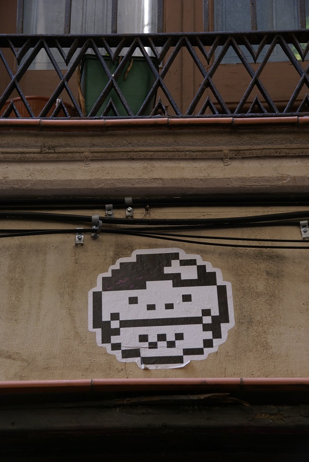 Street art, a space invader perhaps, old Barcelona, Spain